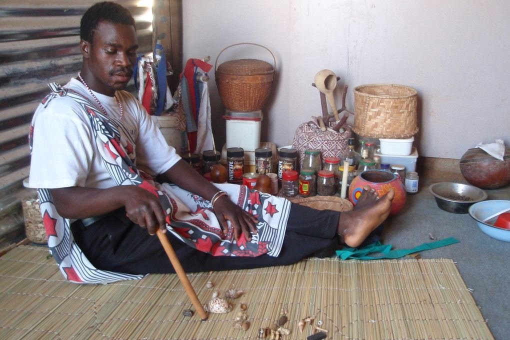 A sangoma, a traditional healer of southern Africa, performing a divination by reading thrown bones