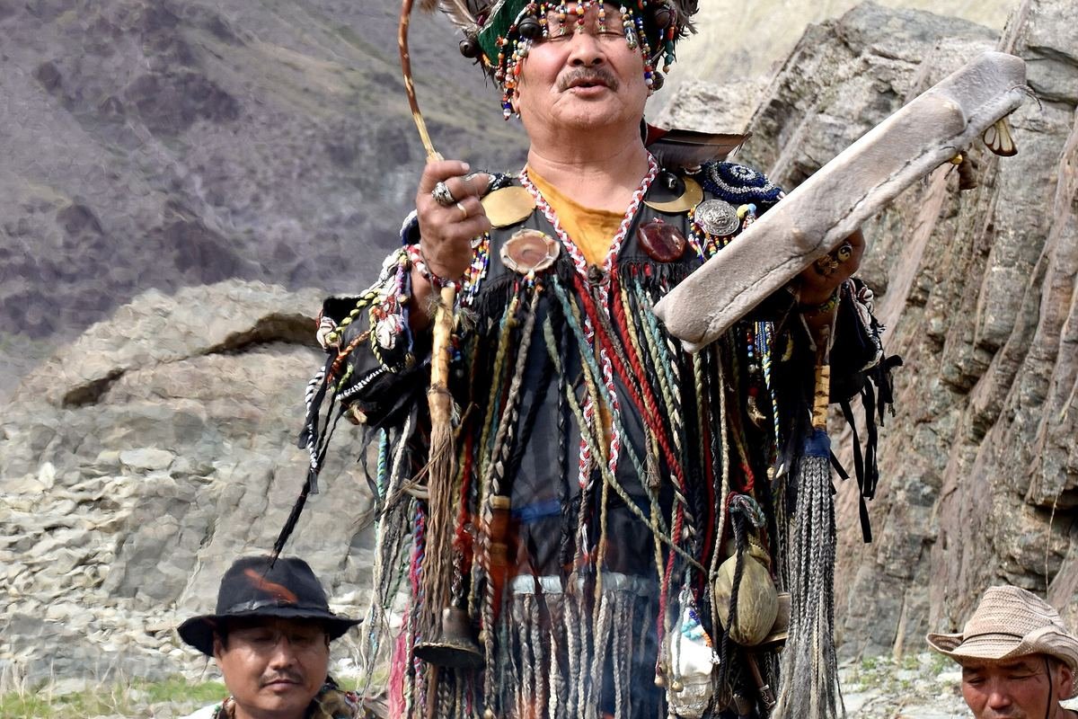 Tuvan shaman Mongush Lazo leading an Ovaa ritual beside a fire in the mountains of Tuva